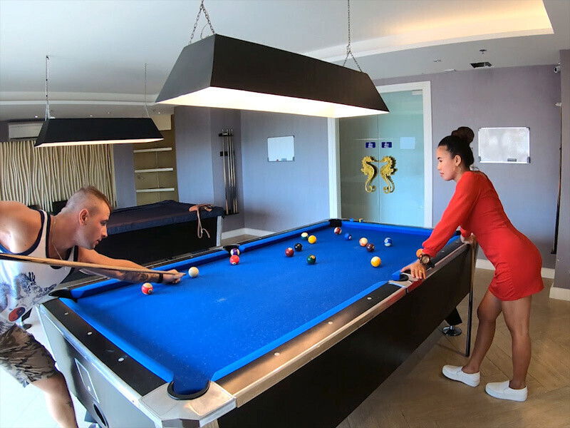 Amateur couple playing pool having passionate