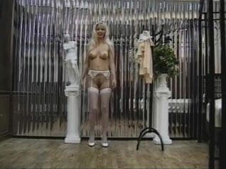 Sexy blonde in stockings shows off her pussy and ass for the camera