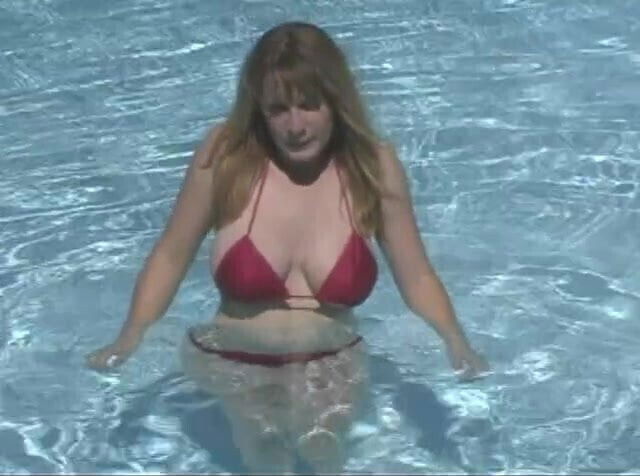 Busty brunette removes bikini swim naked