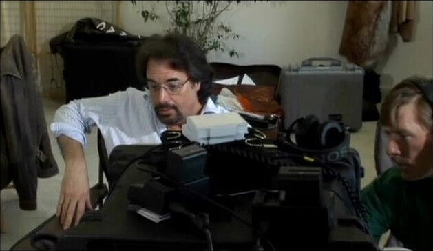 Director oversees films drilling beautiful brunette couch