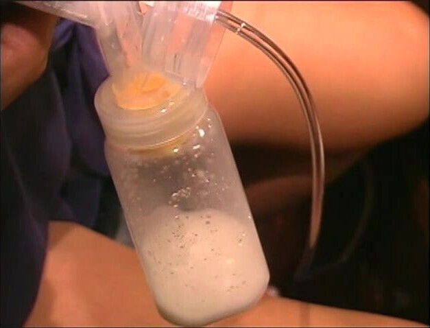 Sexy long haired Latina double pumps milk from her swollen breasts