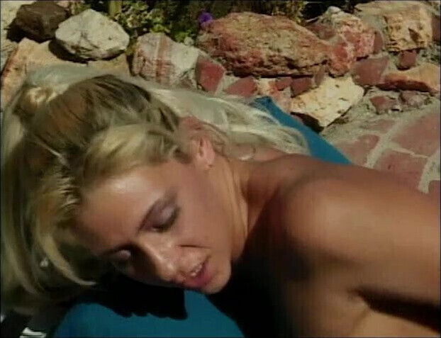 Young lesbians share a doublesided dildo in the sun