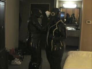 Two rubber girls get their gas masks on.