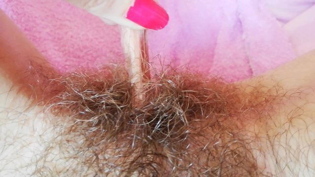 Playing with clit hood pulling stretching hairy bush pussy close