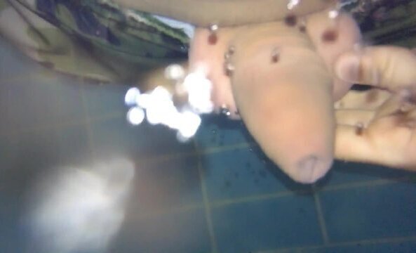 Twink tries hydromassage nozzle uncut public pool underwater
