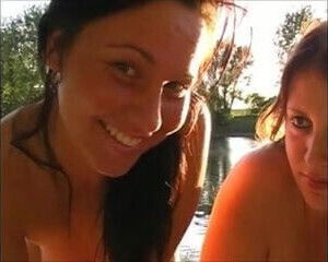 Two babes nice hangers give hj at the lake