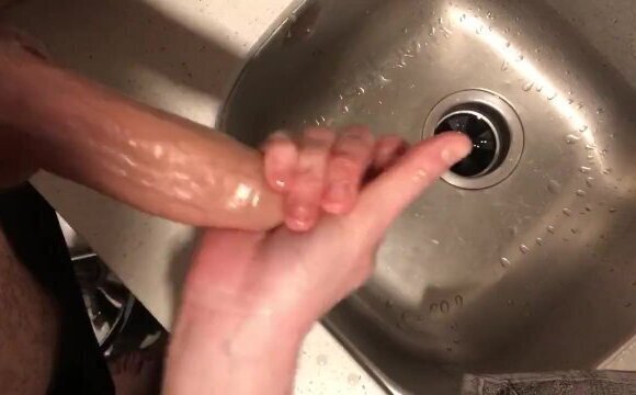 Jerking him off and edging him oiled up in the sink