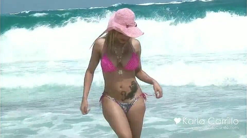 Karla Carrillo in the pink hat on the beach