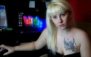 Tatooed blonde tapping fingers.