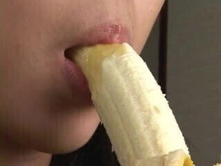 Beautiful Japanese girl sexily eating a banana