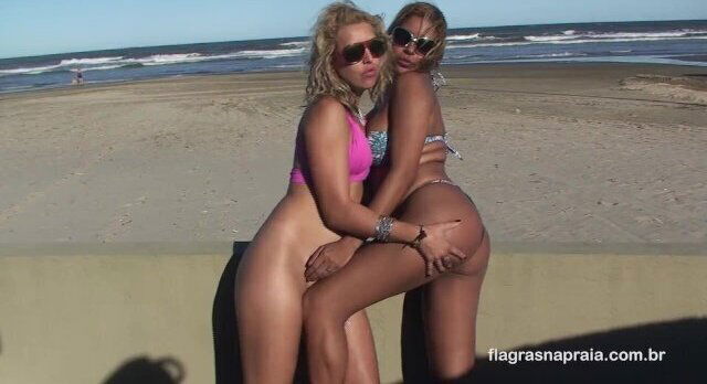 Two hot girls suck each other on public beach in Brazil