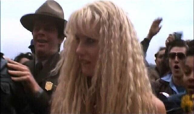 Daryl Hannah nude walking across some grass with bare