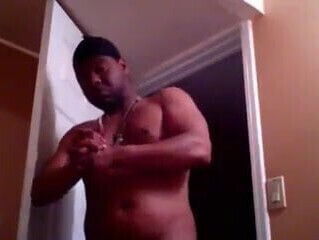 black man rubbing lotion on sexy chest!