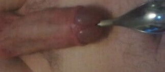 Penis sounding with spoon