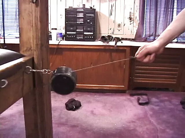 Redheaded mistress pulls weights attached bondaged