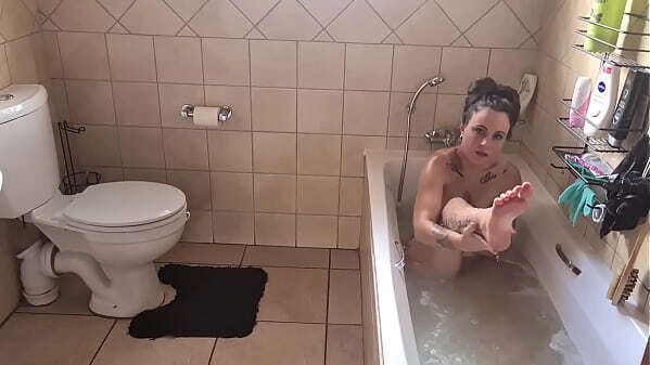 Fully tattooed young MILF with small boobs bathing herself bathtub