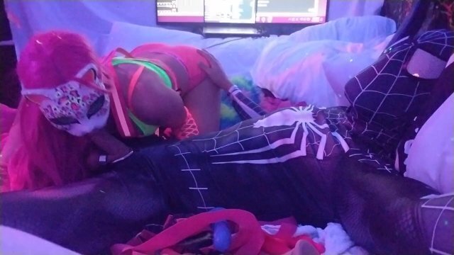 @SexyNeonKitty sucking on Spiderman's cock while getting finger fucked.