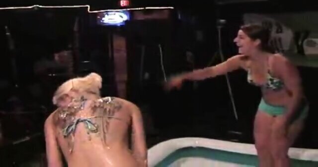 Very oily and shiny girls wrestle for the pleasure of the audience