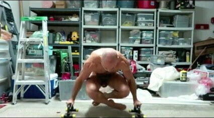 Dad practicing his posing routine in the garage