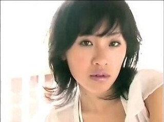 Asian woman teases with breasts (softcore)