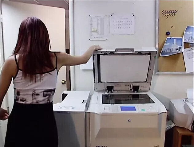 Cute peacheriono with flaming auburn hair asked work fellow explain copier