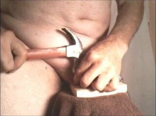 fist-whore nailing balls to a board