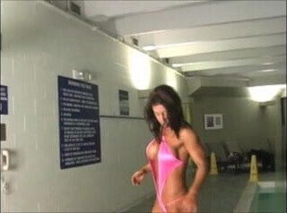 Kaitlyn posing poolside in a revealing Swimsuit