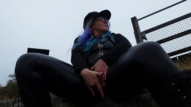 Woman mastrubates beside busy ocean boardwalk waiting