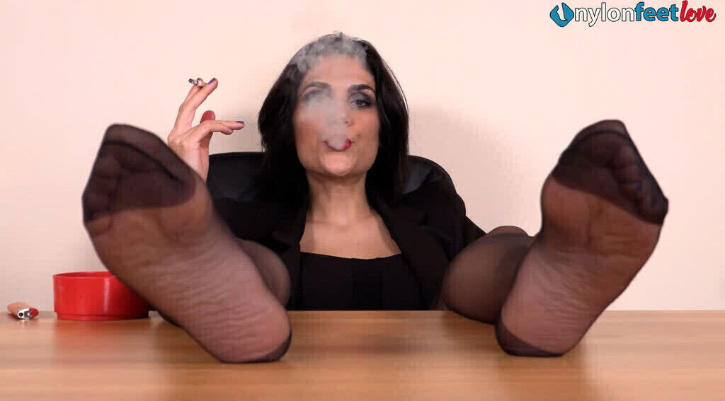 girl puts pantyhose feet your face while smoking