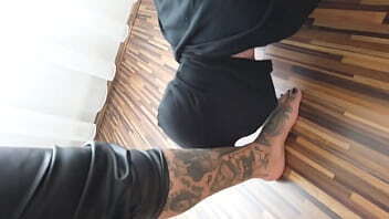 Tattooed lady plays with foot slave