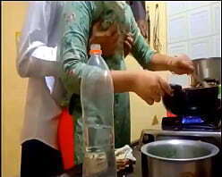 indian new married couple romance in kitchen.