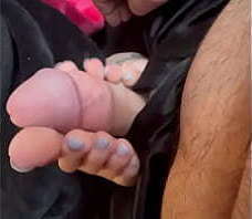 Soaking her feet with cum