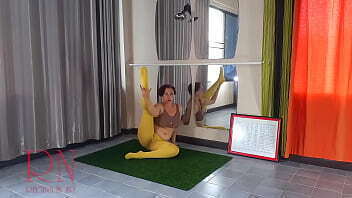 Regina Noir. Yoga yellow tights doing yoga gym. girl without panties doing yoga. athlete trains public yoga room.