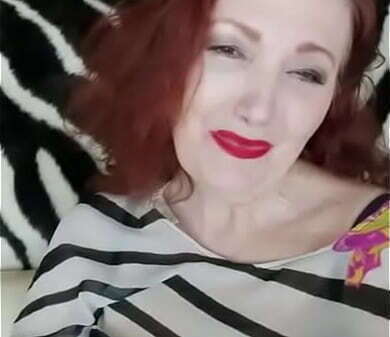 Рыжая дама показывает свои груди бело чёрной блузки