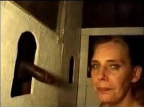 Mature blonde takes black gloryhole booth