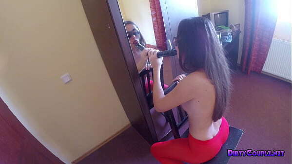 Skinny brunette watching herself mirror sucking dildo