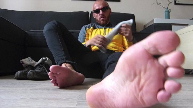 Man's scent showing feet smelling socks.