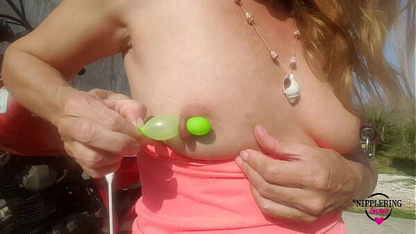 nippleringlover milf sticking balloons through extreme stretched pierced nipples outdoors