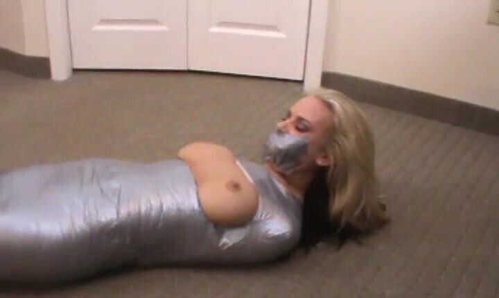 Pretty girl mummified with boobs barefeet exposed