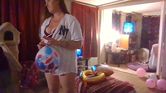 Busty Brunette Popping Balloons Fans