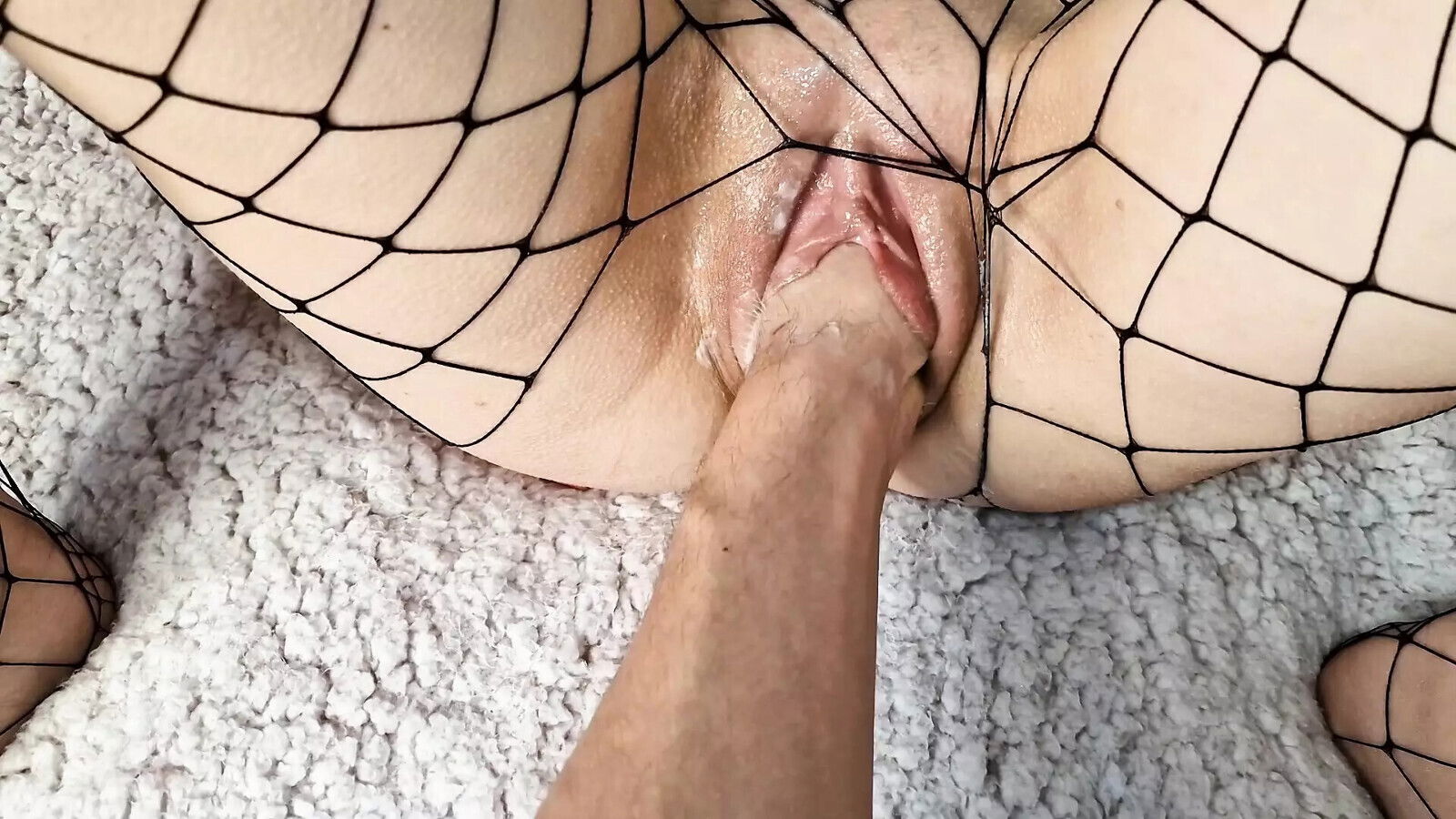 Stretches pussy with fist cock, cumming tummy.