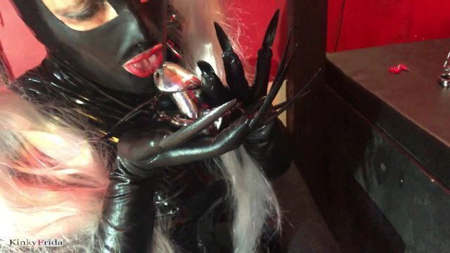Kinky latex Girl with piercings and extremely long nails shows off her collection of chastity cages.