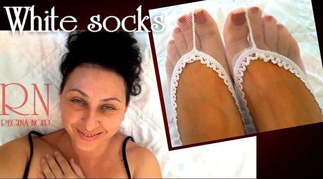 White socks. Cute chick lies bed, smiles, gracefully bends. Nice with white socks