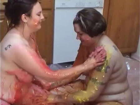 tattooed chicks play with food together kitchen