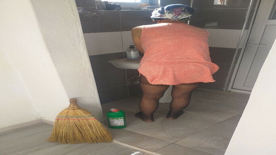 Mature woman hijab cleans house sexy dress