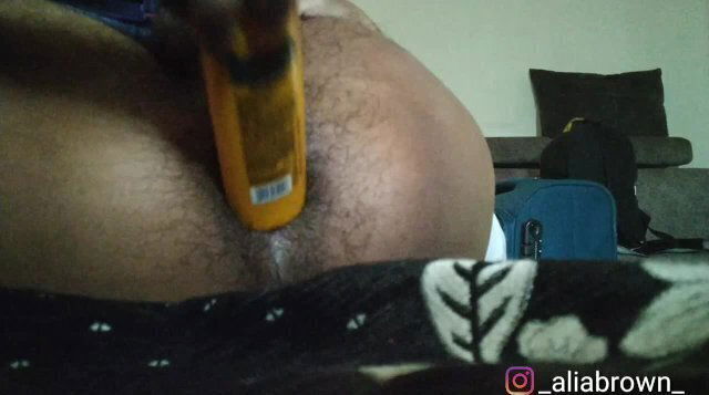 Inserting lotion bottle hairy Brown