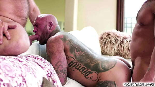 Couples Brock Banks Rick Kelson cuddling sofa thinking Brocks first time topping Rick idea doing role play