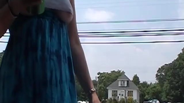 MILF braless wearing crop revealing underboob near roadside with traffic