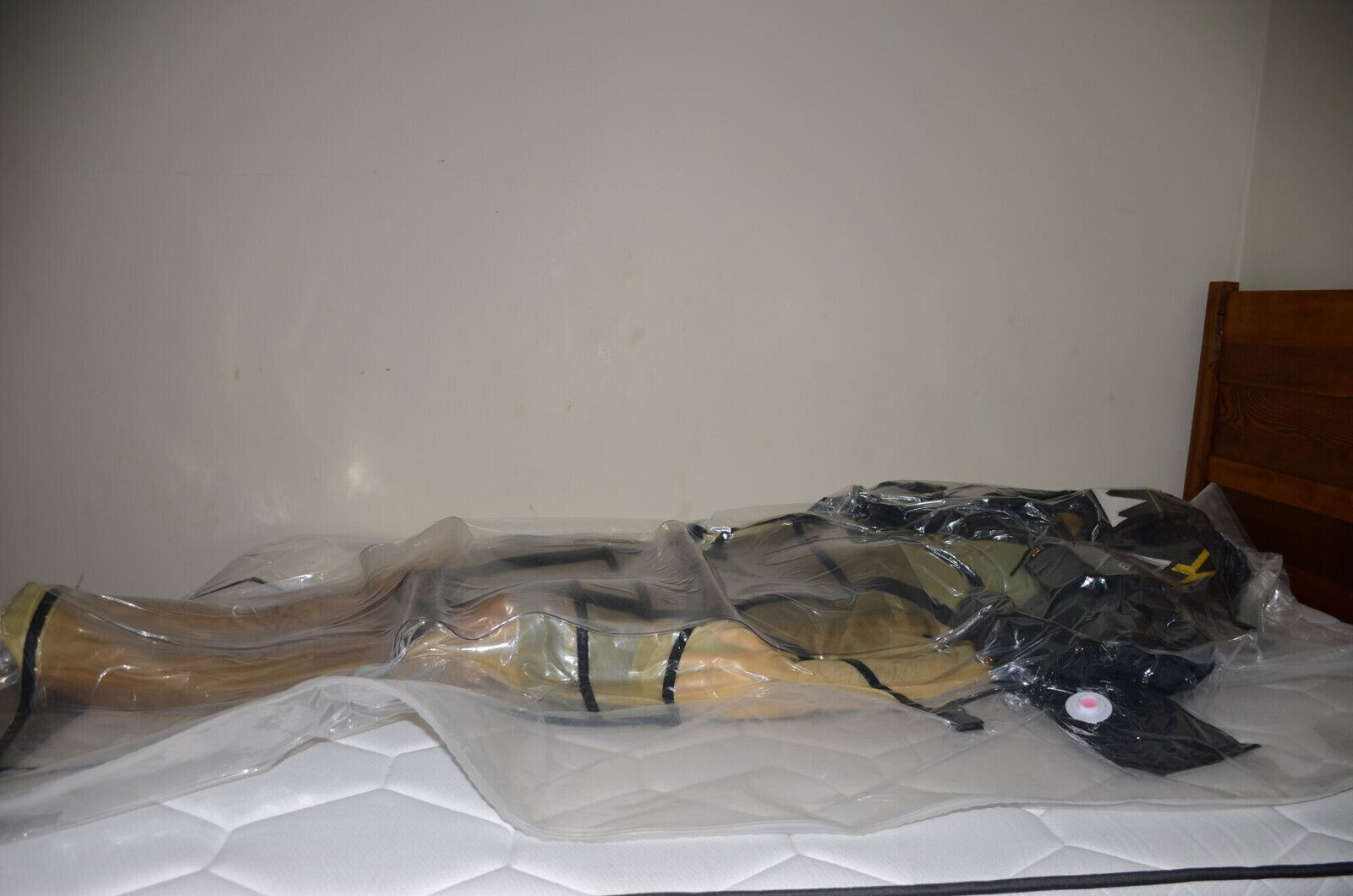 VacPacked latex sleepsack wearing hockey shorts with aprons lead aprons hockey chestie