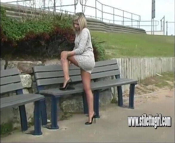 Sexy blonde with shapely legs teases in tall black stilettos